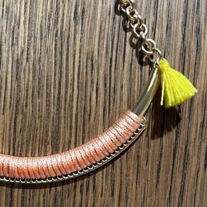 Necklace, copper tone, pink thread and yellow tassel detail